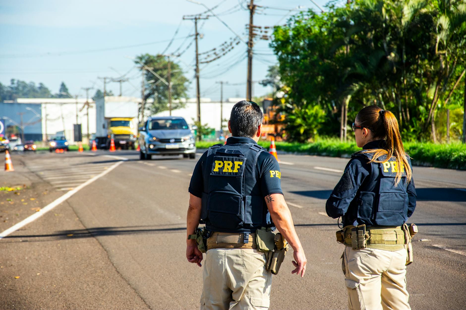 back view of police officers standing on a street